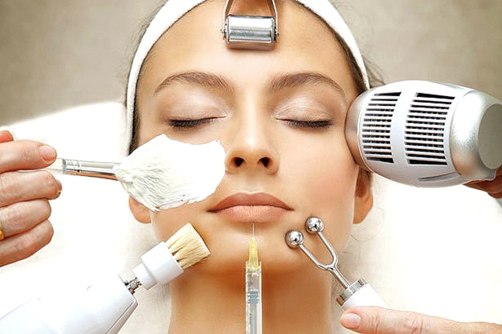 A woman enjoying a facial treatment with a beauty device, highlighting a tranquil and rejuvenating experience.